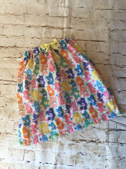 Elasticated skirt (6-7 years), in Polly cotton fabric with Carebear design with an 8cm yellow bow